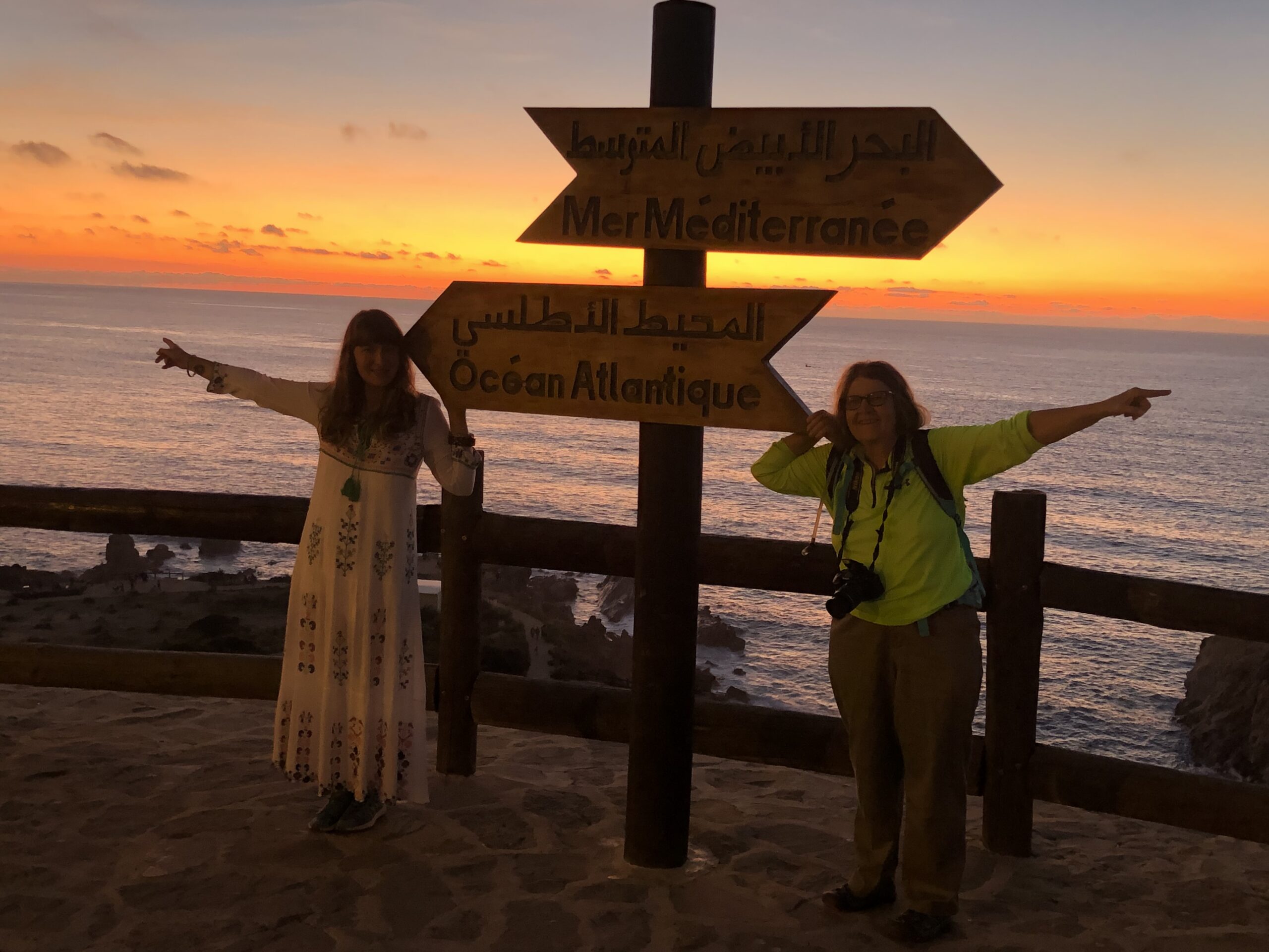 two women at signs pointing to Atlantic and Mediterranean